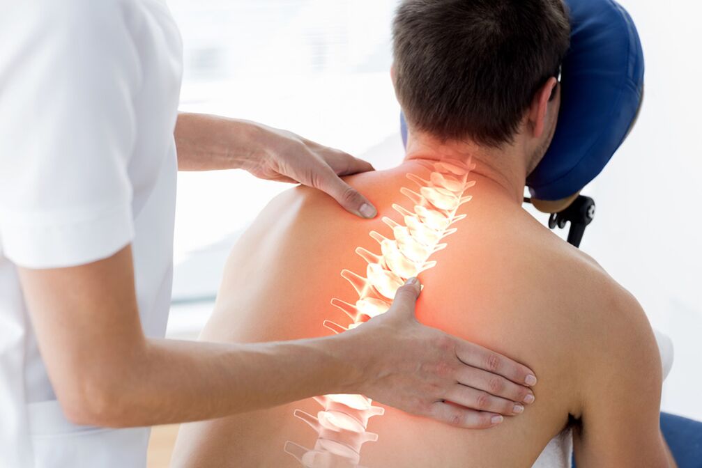 doctor examines the back with thoracic osteochondrosis